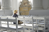 Eine Frau sitzt in einer Kapelle und genießt die Ruhe.